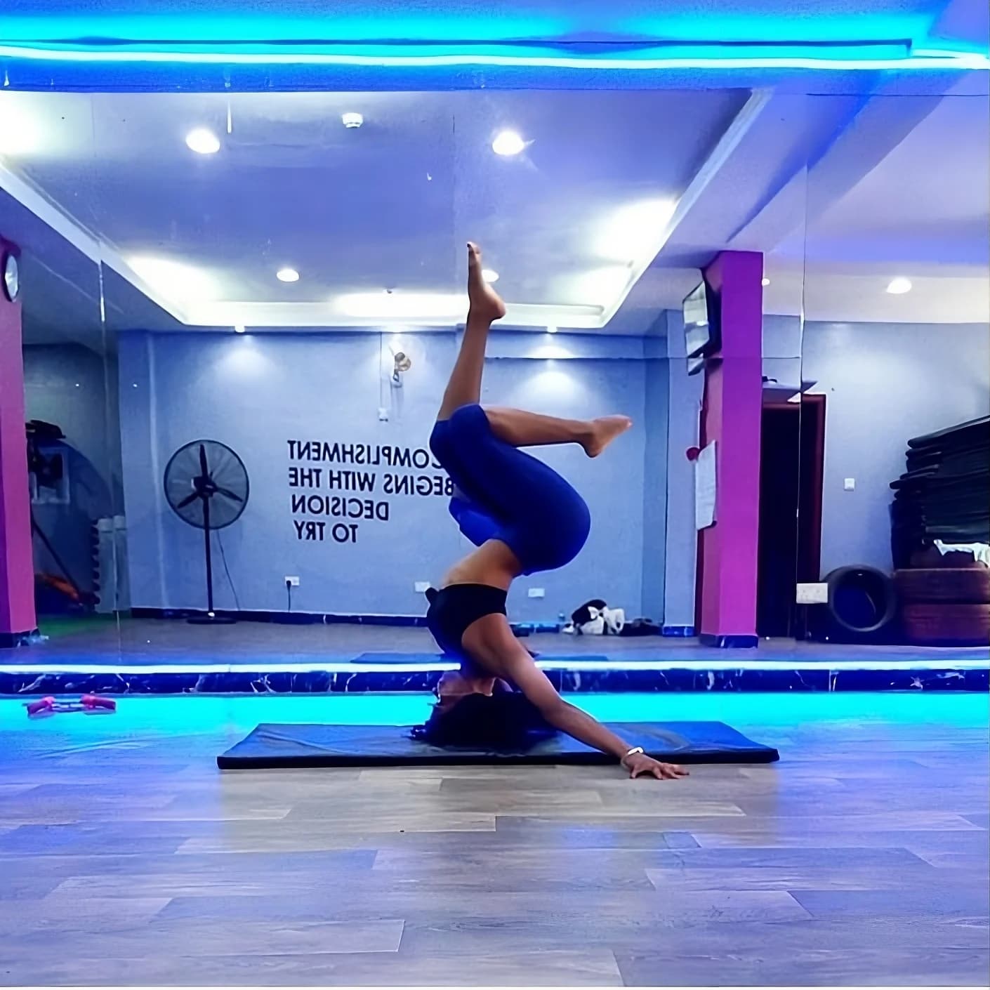 Woman stretching into a yoga pose on a mat